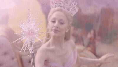 Woman In Pink Dress Beside Woman On Bed GIF