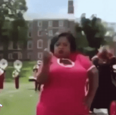 Woman In Pink Dress Dancing Front Of Band GIF
