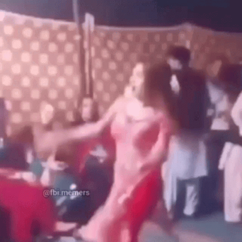 Woman In Pink Dress Dancing In Front Of Crowd GIF