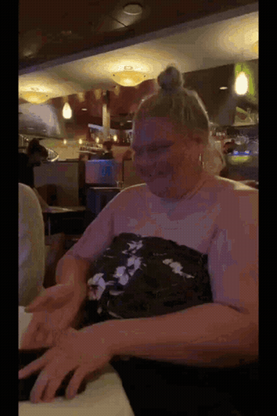 Woman In Pink Dress Dancing In Front Of Crowd GIF