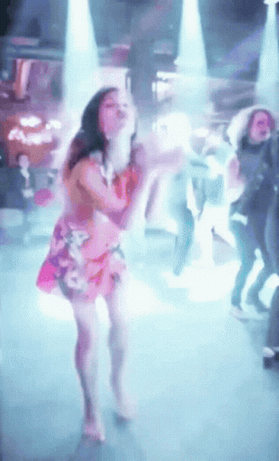 Woman In Pink Dress Dancing In Front Of Crowd GIF