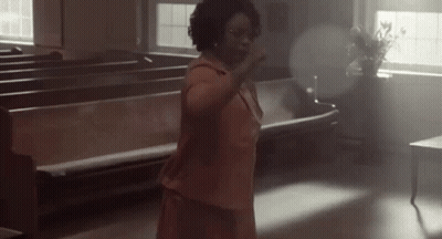 Woman In Pink Dress Hands Up In Church GIF