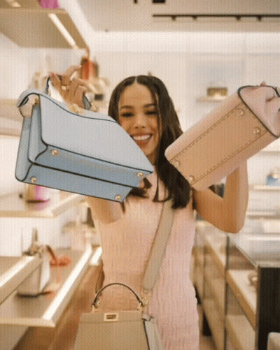 Woman In Pink Dress Holding Blue And Pink Purses GIF