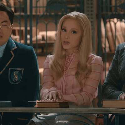Woman In Pink Dress Holding Book At Table GIF