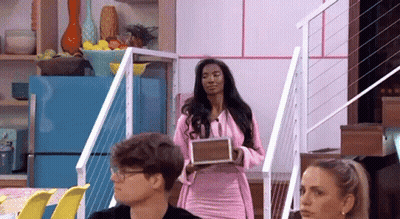 Woman In Pink Dress Holding Box To Couple GIF