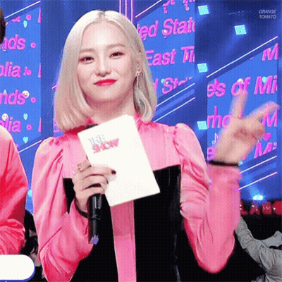 Woman In Pink Dress Holding Microphone And The Show GIF