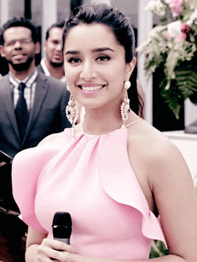 Woman In Pink Dress Holding Microphone Smiling GIF