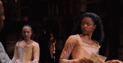Woman In Pink Dress Holding Paper On Stage GIF