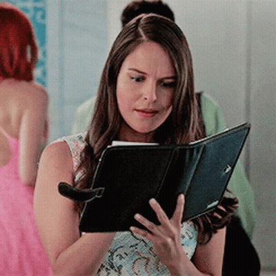 Woman In Pink Dress Holding Tablet GIF