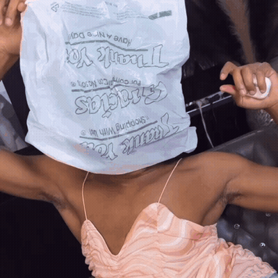 Woman In Pink Dress Holding Thank You Bag GIF