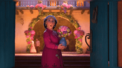 Woman In Pink Dress Holding Vase Of Flowers GIF