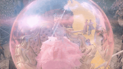 Woman In Pink Dress Holding Wand In Bubble GIF