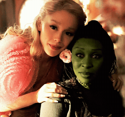 Woman In Pink Dress Hugging Woman In Green Dress GIF
