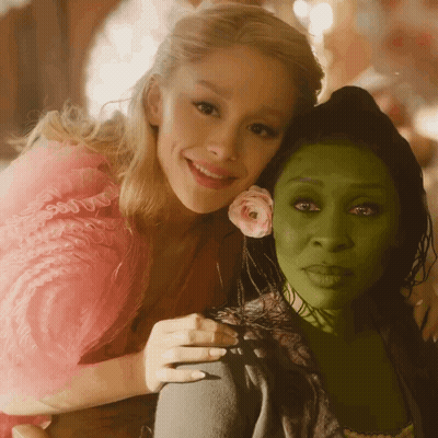 Woman In Pink Dress Hugging Woman In Green Dress GIF