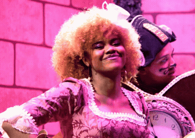 Woman In Pink Dress In Front Of Clock At 3:00 GIF