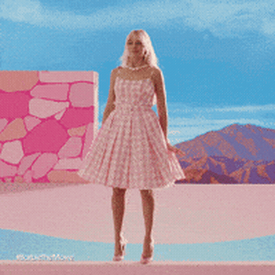 Woman In Pink Dress In Front Of Pink House GIF