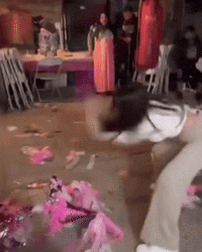 Woman In Pink Dress In Messy Room GIF