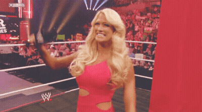 Woman In Pink Dress In Wrestling Ring With WWE Logo GIF