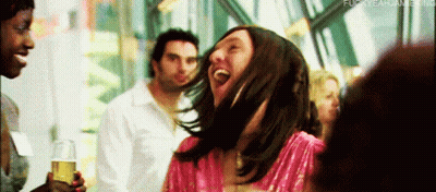 Woman In Pink Dress Laughing Holding Beer GIF