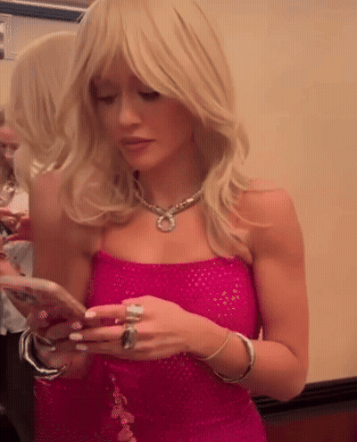 Woman In Pink Dress Looking At Cell Phone GIF