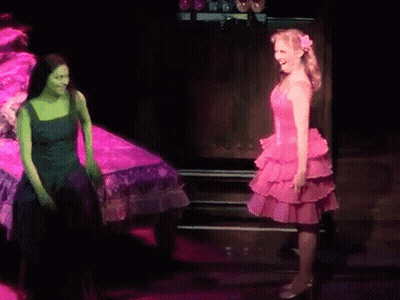 Woman In Pink Dress Next To Woman In Green GIF