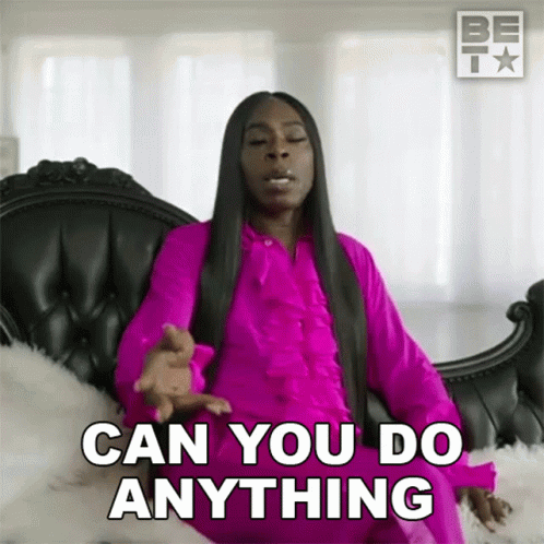Woman In Pink Dress On Black Couch Saying Can You Do Anything GIF