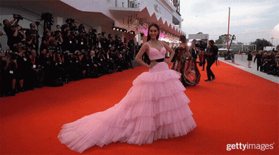 Woman In Pink Dress On Red Carpet Getty Images GIF