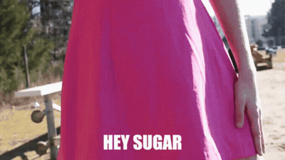 Woman In Pink Dress Saying Hey Sugar GIF