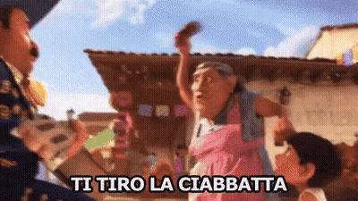 Woman In Pink Dress Says Ti Tiro La Ciabatta GIF