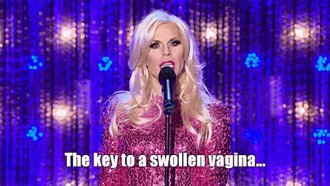 Woman In Pink Dress Singing Into Microphone GIF