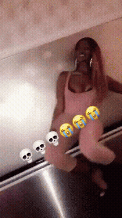Woman In Pink Dress Sitting In Front Of Skull Wall GIF