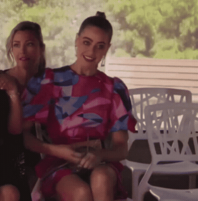 Woman In Pink Dress Sitting Next To Another Woman GIF