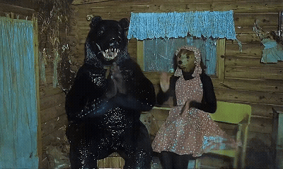 Woman In Pink Dress Sitting Next To Bear GIF