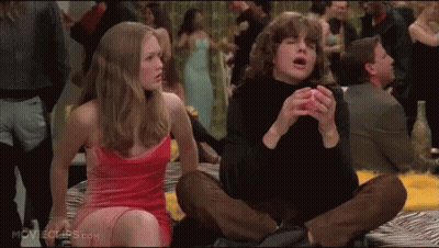 Woman In Pink Dress Sitting Next To Man In Black Shirt GIF