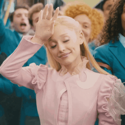 Woman In Pink Dress Smiling And Waving Hand GIF