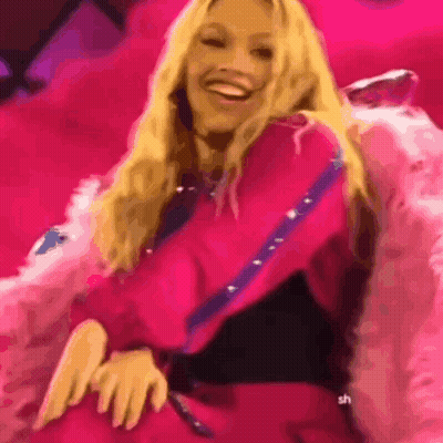 Woman In Pink Dress Smiling In Pink Chair GIF