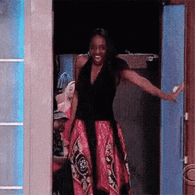 Woman In Pink Dress Standing In Doorway GIF