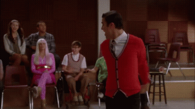 Woman In Pink Dress Standing In Front Of Crowd GIF