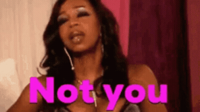 Woman In Pink Dress Standing In Front Of Not You Sign GIF