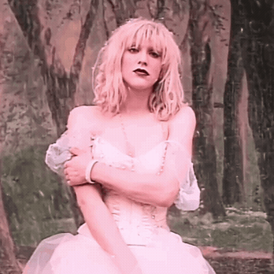 Woman In Pink Dress Standing In Woods GIF