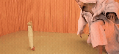 Woman In Pink Dress Standing Next To Smaller Woman GIF