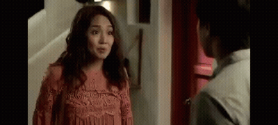 Woman In Pink Dress Talking To Man In White GIF