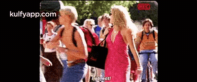 Woman In Pink Dress Talking To Man In Yellow Shirt GIF