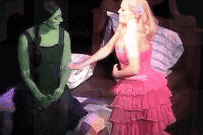 Woman In Pink Dress Talking To Woman In Green Dress GIF