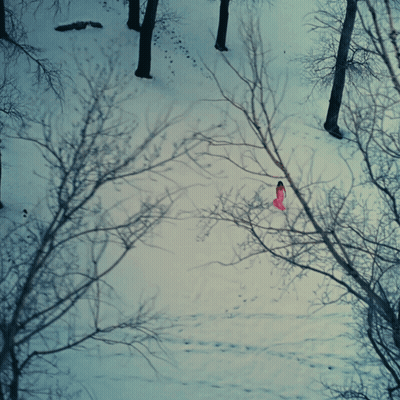 Woman In Pink Dress Walking Through Snow GIF