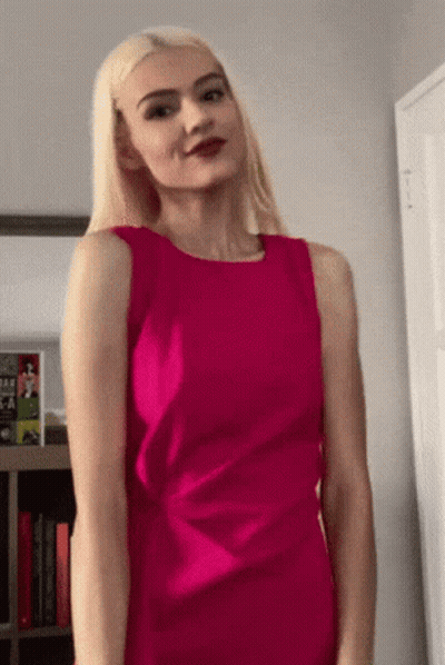 Woman In Pink Dress With Book Titled A Woman GIF