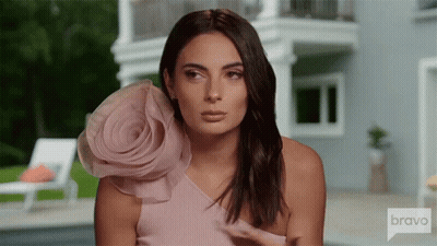 Woman In Pink Dress With Flower At House On Bravo GIF