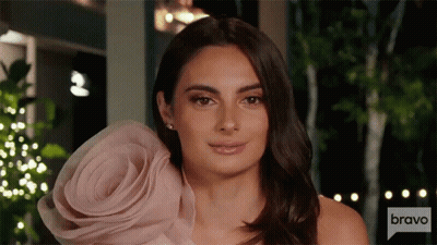 Woman In Pink Dress With Flower On Sleeve GIF