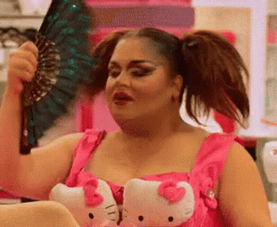 Woman In Pink Dress With Hello Kitty Slippers Holding Fan GIF