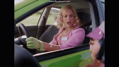 Woman In Pink Driving Green Car Talks To Purple Hat Man GIF